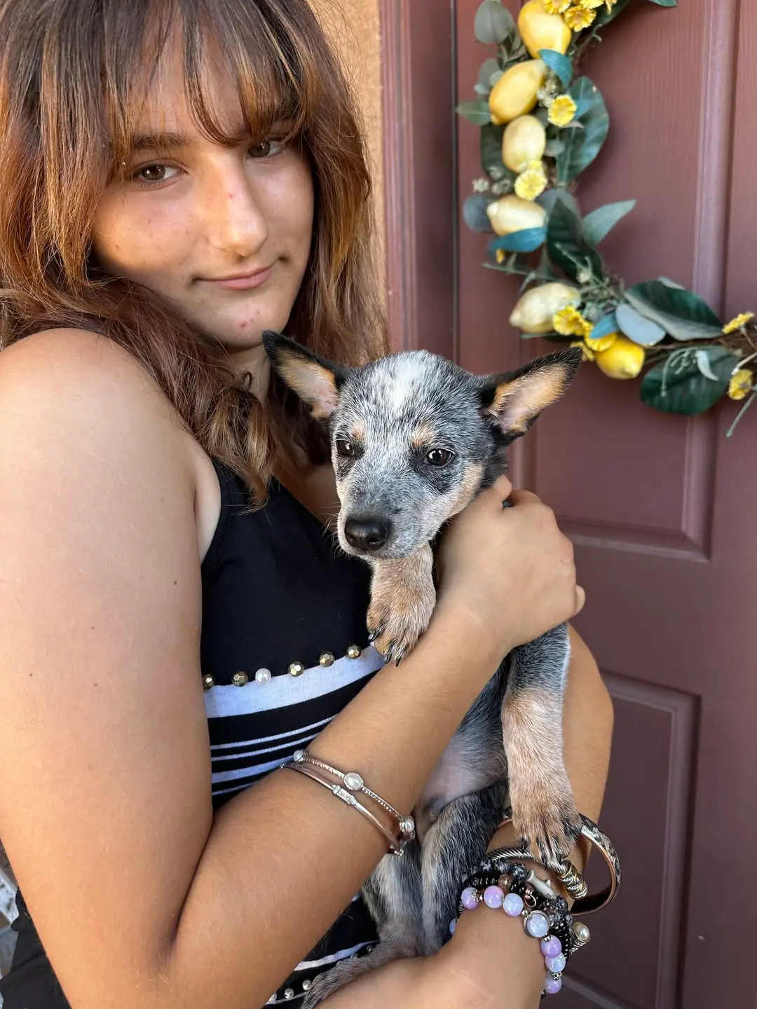 Dean, now named Guillermo, held by a member of his new family in front of their front door
